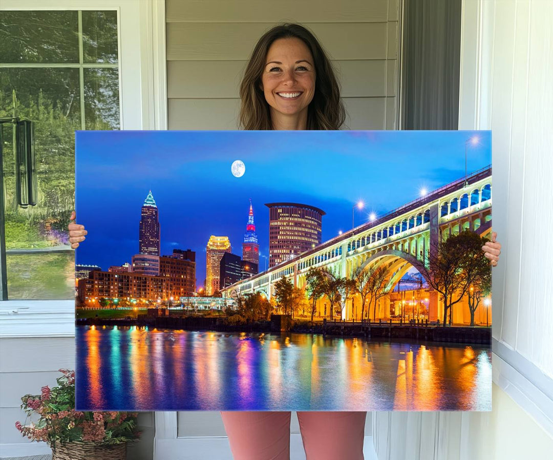 A Cleveland Night Skyline Wall Art on museum-quality canvas showcases a bridge and illuminated buildings.