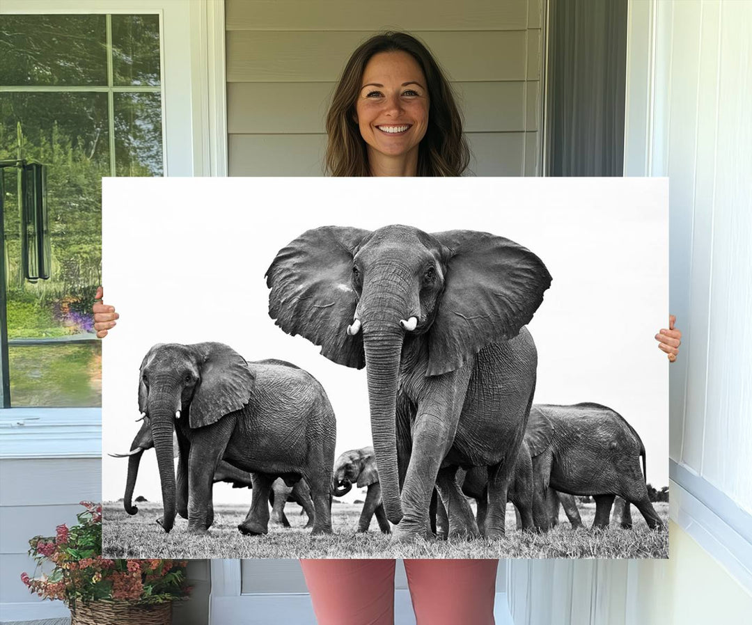 A modern dining area features a Black White Elephant Family Wall Art Canvas Print.