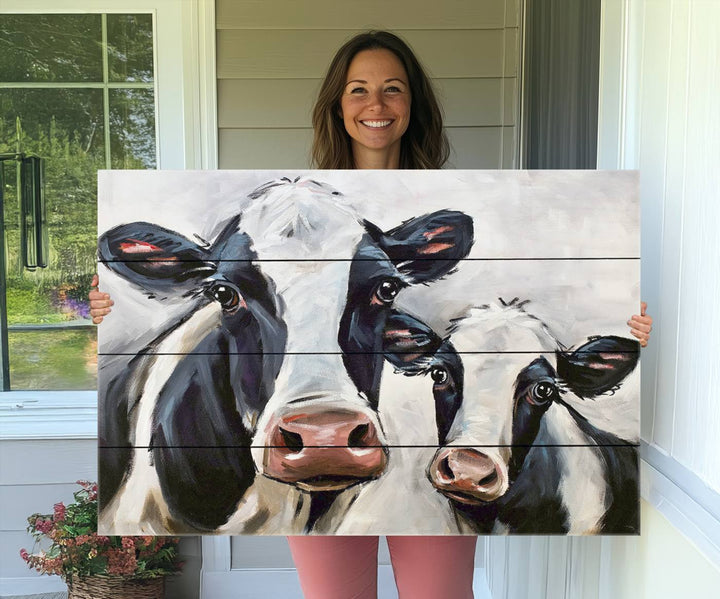 The Vintage Baby and Mom Cattle Canvas, featuring cows with black and white patches, is a prominent piece of wall art.