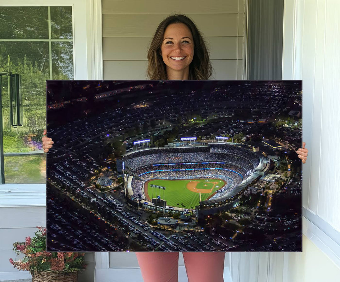 A large Los Angeles Dodgers print of Dodger Stadium at night is displayed near a window.