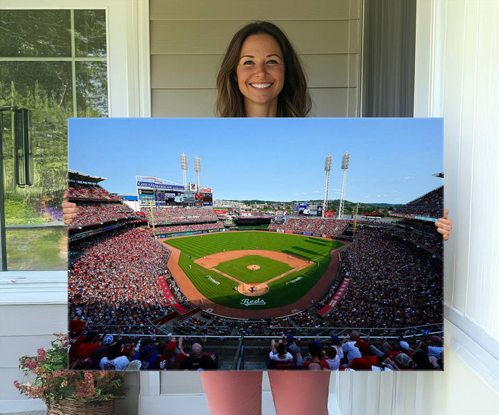 The Cincinnati Reds Baseball Team print of Great American Ball Park Stadium adorns the wall.