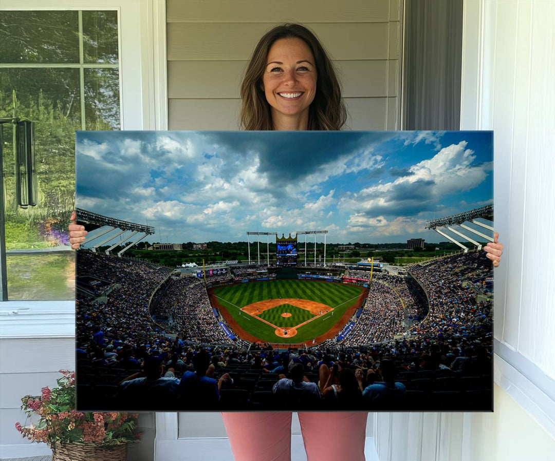 A 3-panel print of Kauffman Stadium, showcasing a crowded baseball field under cloudy skies.