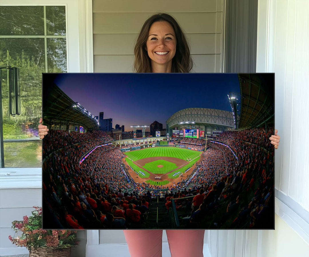 A canvas print of Houston Minute Maid Park at dusk is mounted on the wall.