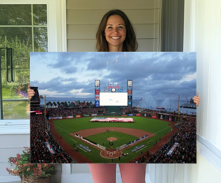 This framed 3-panel canvas MLB wall art features a giant flag and fans under a cloudy sky at Oracle Park.