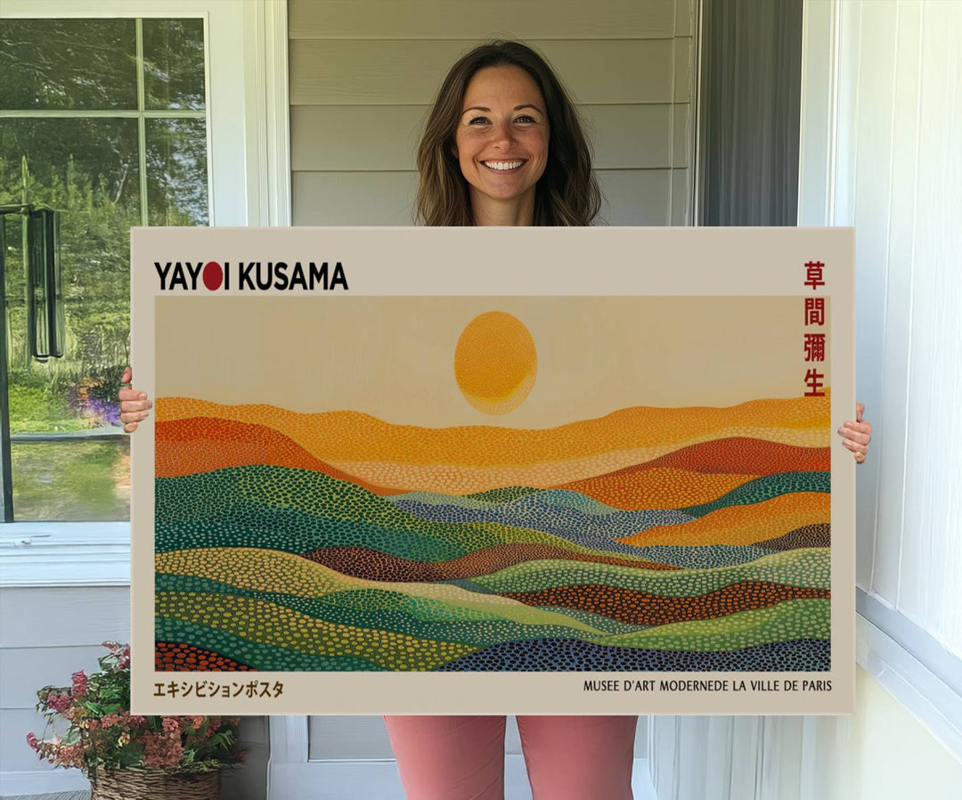 A framed Yayoi Kusama 1986 wall art print showcases a vibrant abstract landscape with colorful, wavy dots and a sun above the horizon.