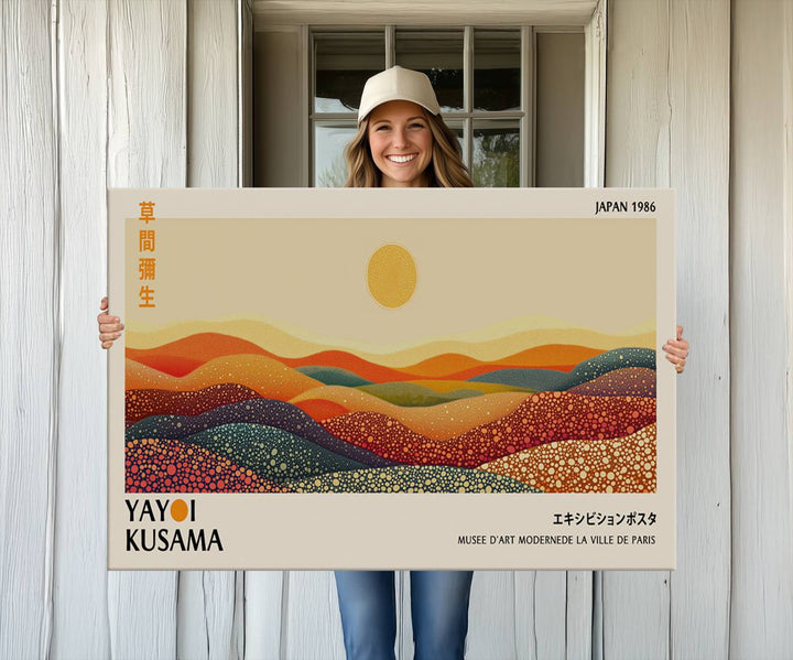 The Yayoi Kusama Wall Art Print is a vibrant abstract landscape canvas featuring colorful, dotted hills and a sun, reminiscent of Yayoi Kusama's iconic designs.