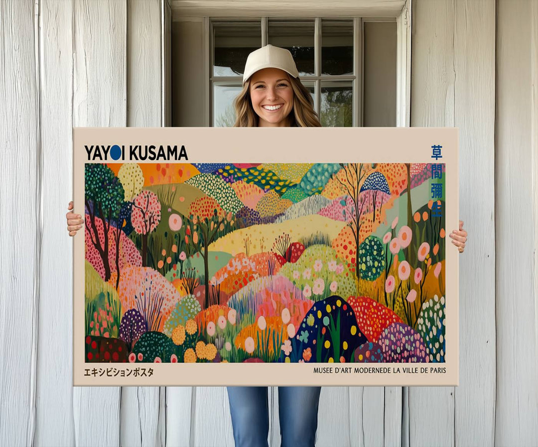 A framed Yayoi Kusama Wall Art Canvas Print features a vibrant abstract landscape adorned with flowers.