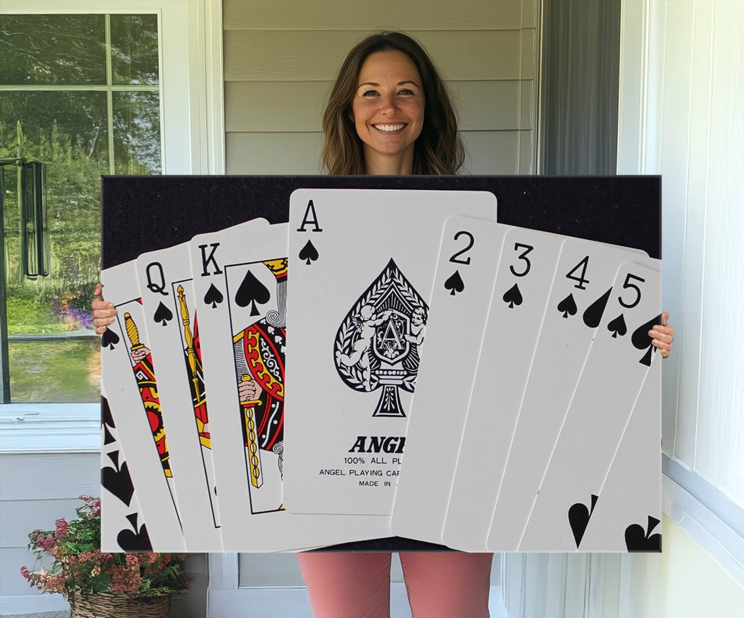 The Poker Wall Art - Playing Cards Canvas Wall Art Print features an Ace of Spades and Royal Flush design. This piece adds a classic charm to any space with its subtle emphasis on the Ace of Spades, making it perfect for game room decor.