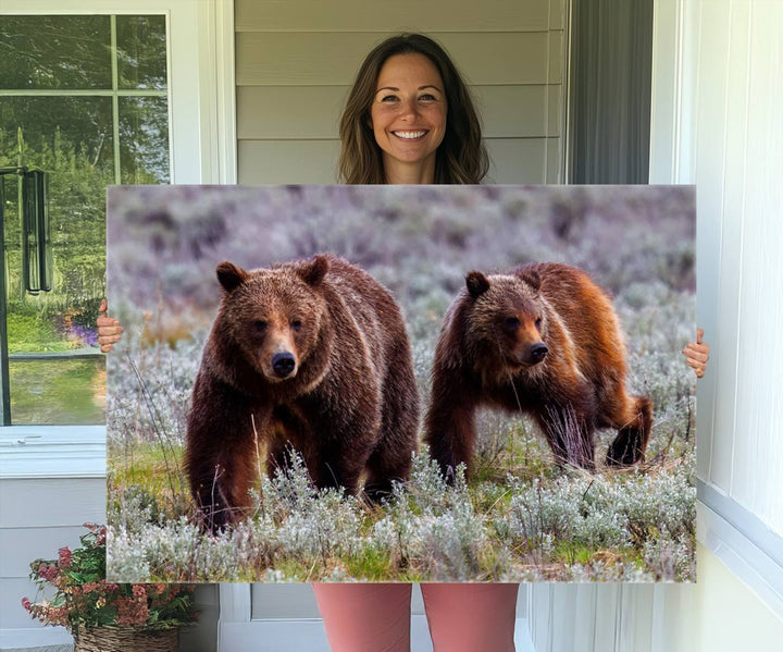 The "Queen of the Tetons" is a stunning canvas art print featuring Grizzly 399 and two bears strolling through a grassy field. Its gallery-quality finish beautifully captures the essence of nature, making it perfect for rustic home decor.