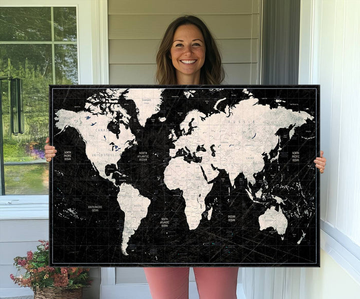 The Black & White World Map Canvas Wall Art, a giclee print, elegantly decorates the wall.