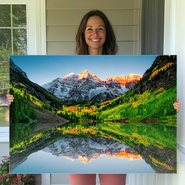 The Sunrise Maroon Bells Lake Wall Art Print beautifully captures North Maroon Peak mirrored in the tranquil lake, framed by lush greenery.