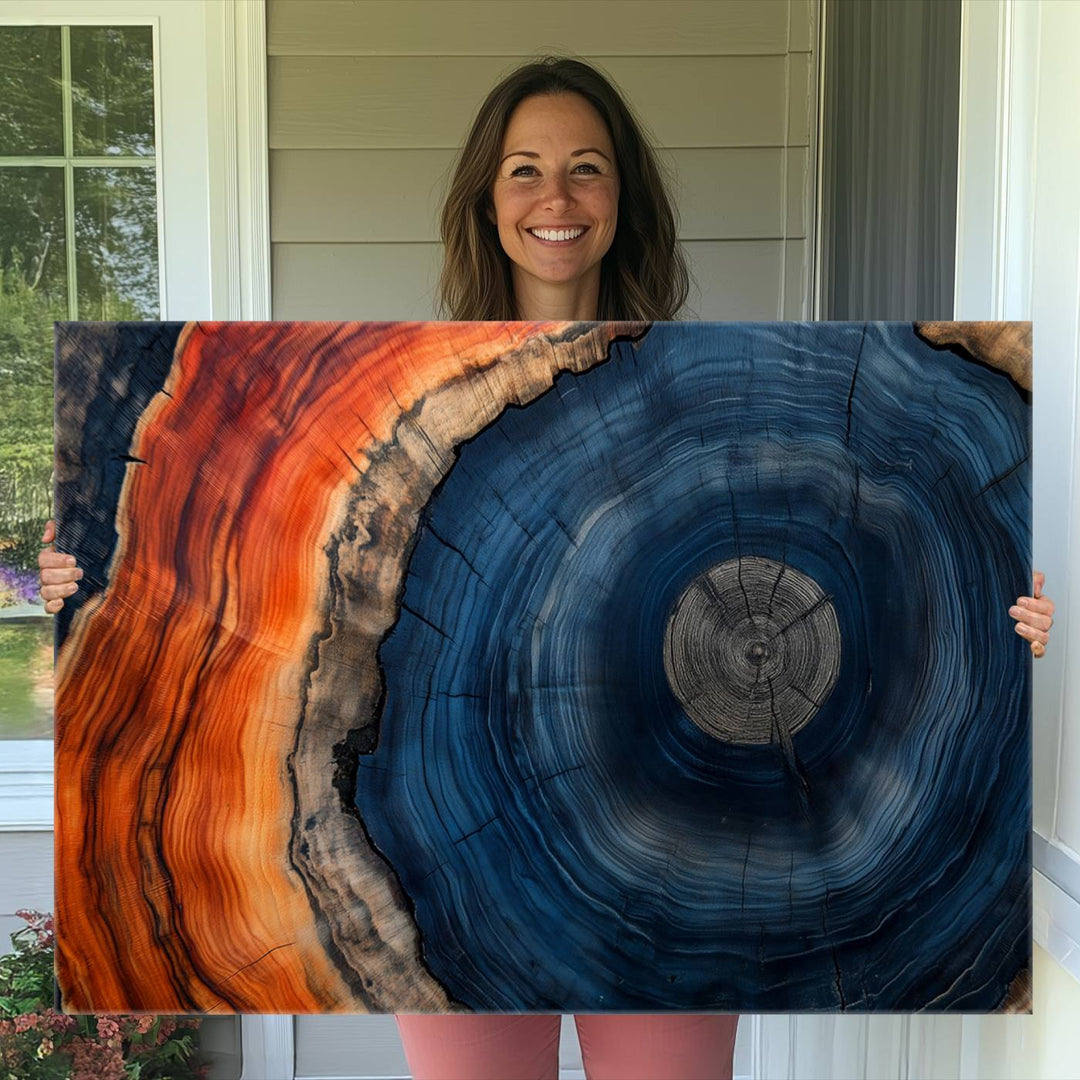 Abstract Tree Ring Wall Art Print on canvas featuring vibrant blue, orange, and brown rings with a natural rustic wood texture. Free shipping available!.