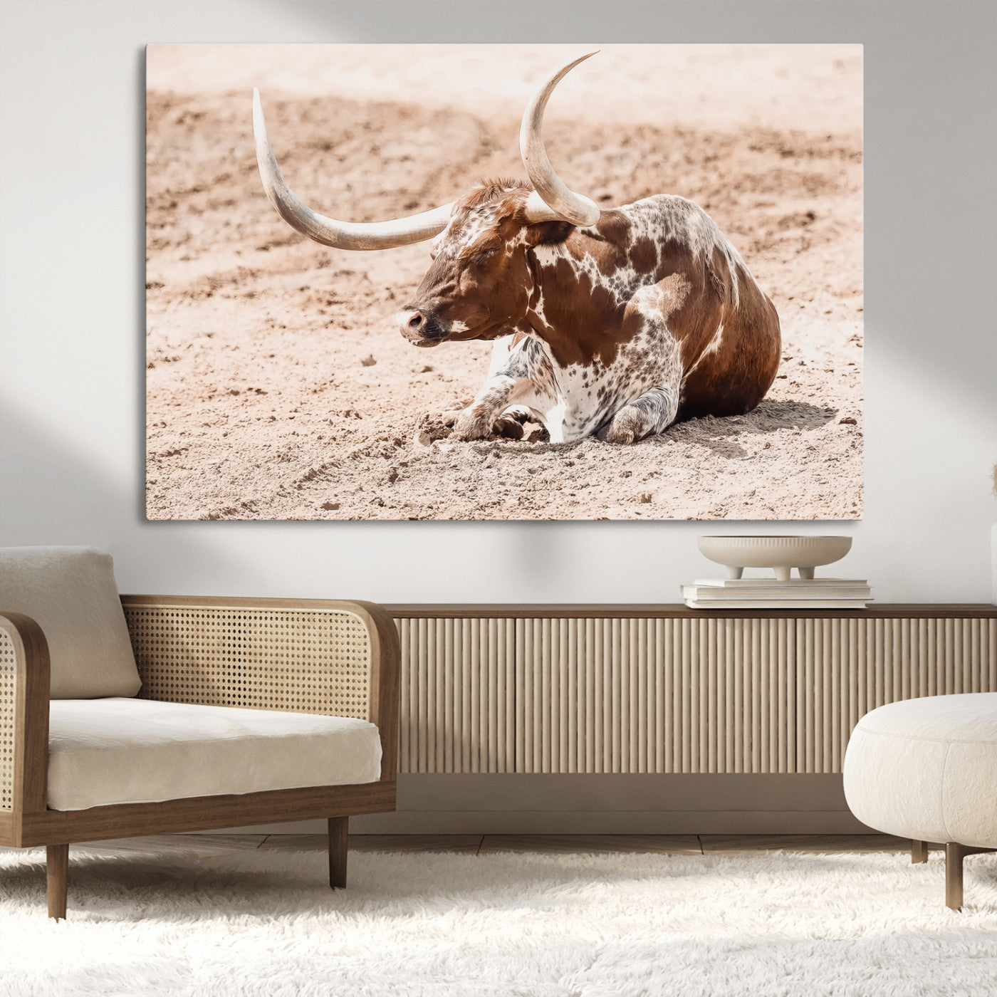 Texas Longhorn bull resting on dusty ground with warm tones, ideal for rustic western or farmhouse-themed wall decor.