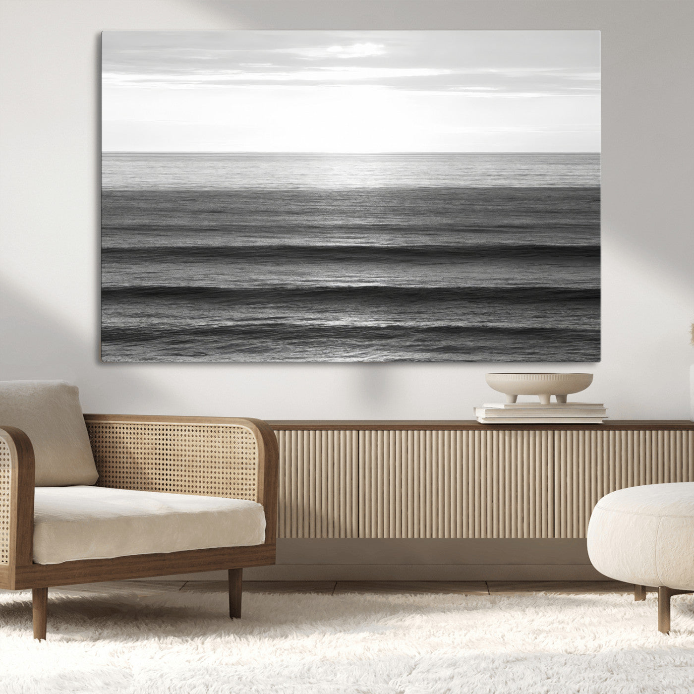 Minimalist black and white ocean view with layered waves reflecting sunlight, evoking a sense of calm and coastal serenity.