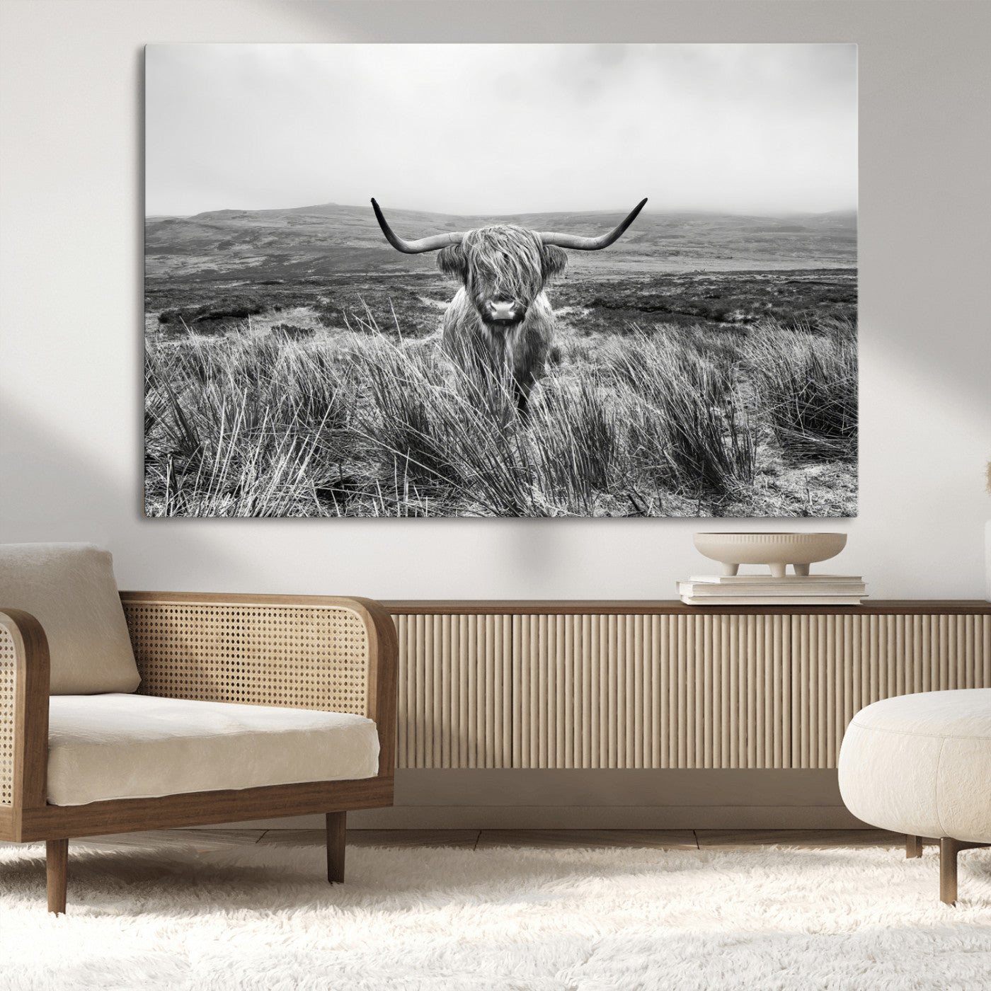 A black and white portrait of a Highland cow in a foggy Scottish countryside, capturing a rustic aesthetic and tranquil farm escape.