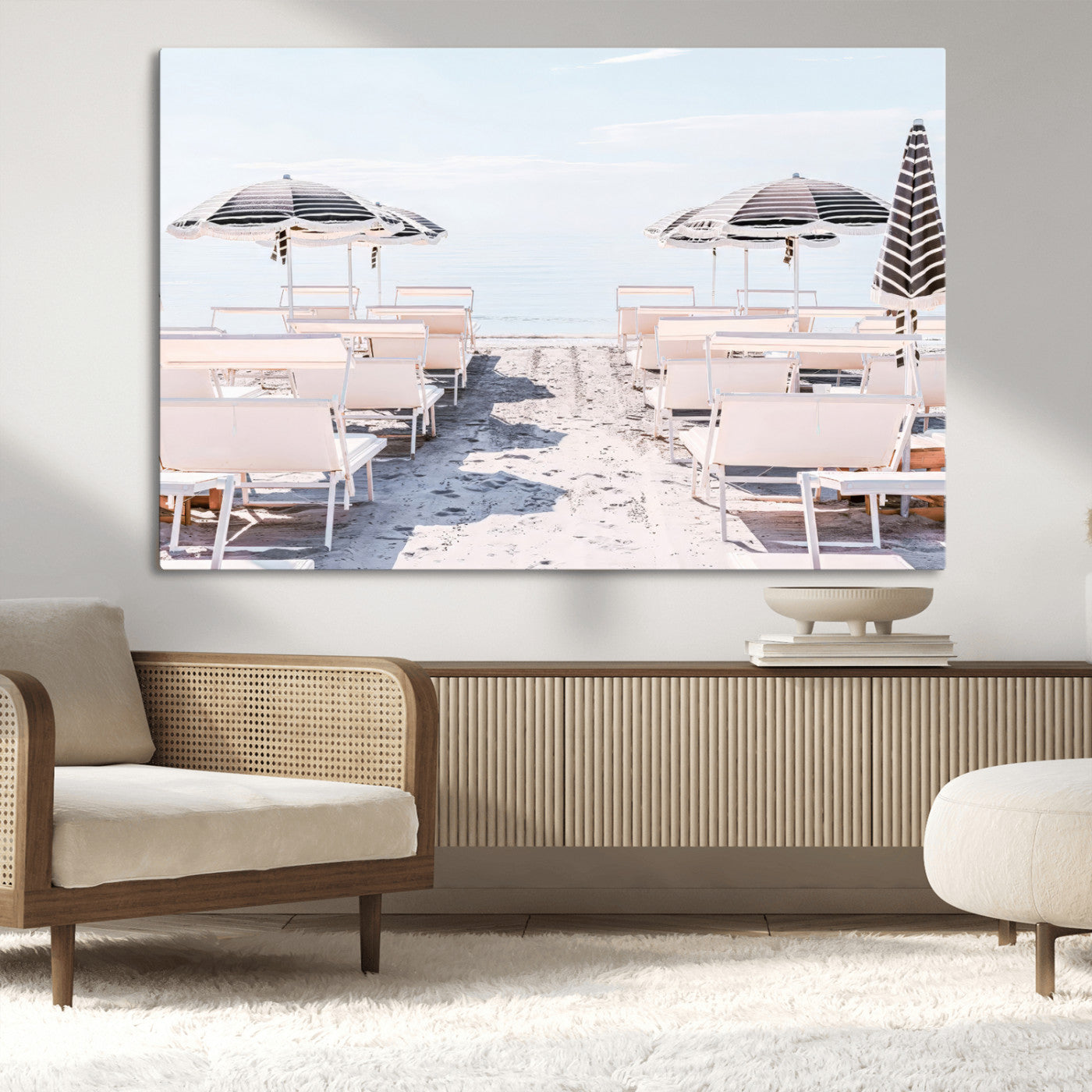 A serene minimalist beach scene featuring striped umbrellas, soft pastel sand, and an elegant lounge setup, creating a tranquil and stylish coastal retreat.