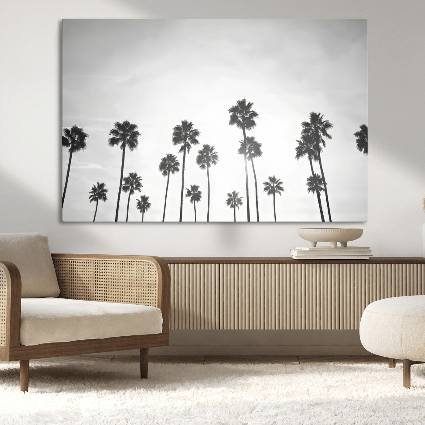 A black and white minimalist scene featuring tall palm trees silhouetted against a bright sky, creating a dreamy and timeless tropical aesthetic.