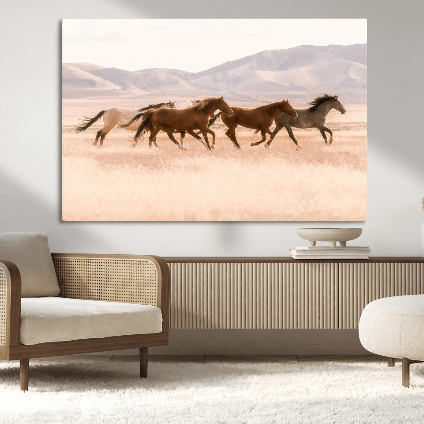 A herd of wild horses galloping through a sunlit desert plain with mountains in the background, perfect for rustic or western-themed wall decor.