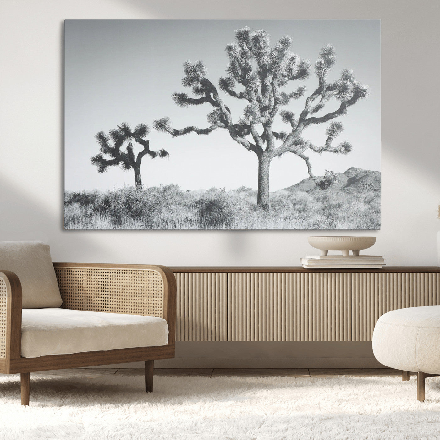 Two Joshua trees in a black and white desert landscape with distant hills, ideal for boho or rustic interior wall styling.