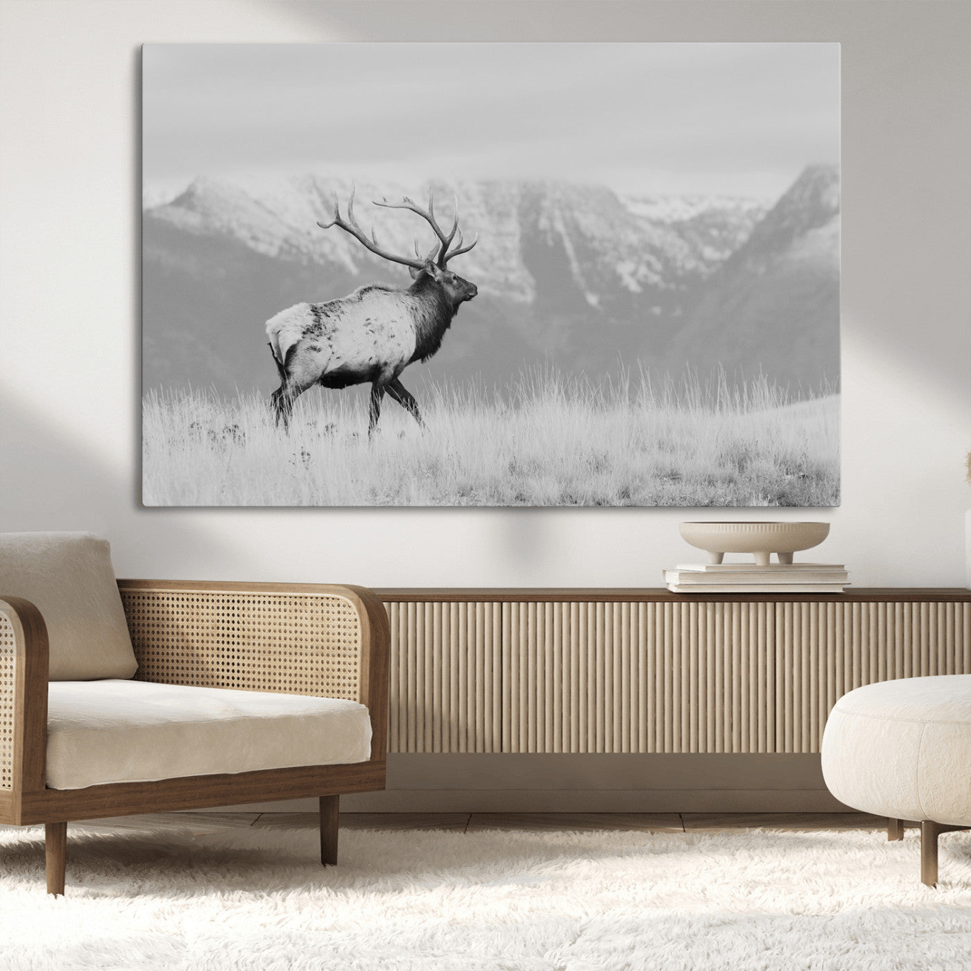 Black and white elk standing in front of snowy mountain range, perfect for rustic lodge or nature-inspired wall decor.