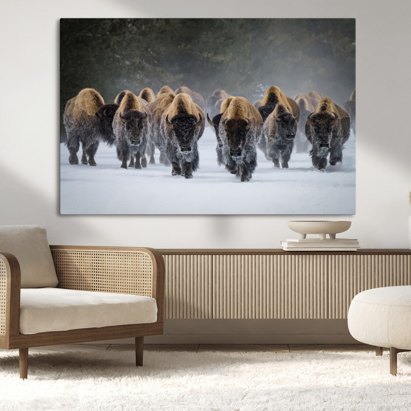 A herd of American bisons walking through deep snow in a forest, evoking a powerful rustic wilderness mood for western-style interiors.