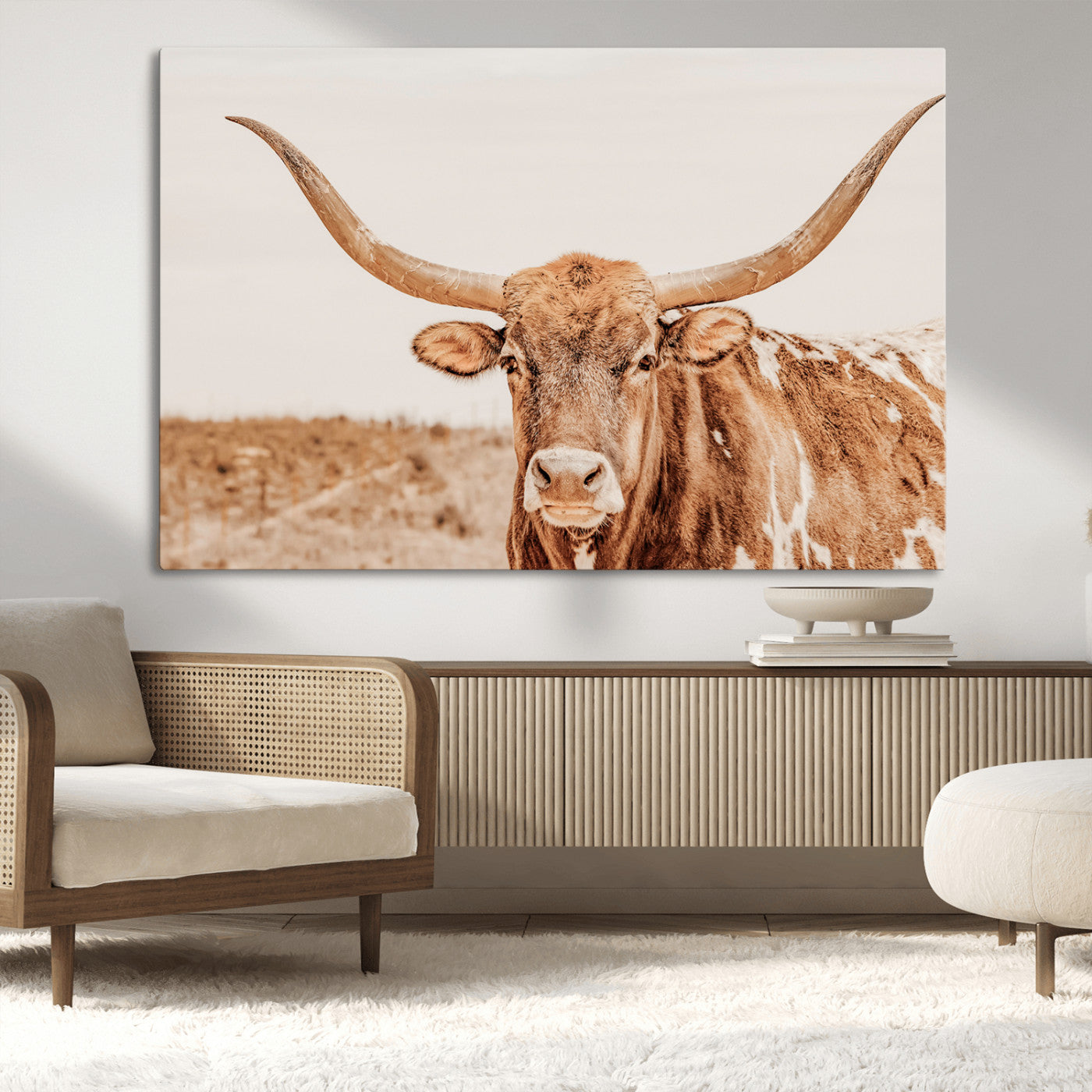 A longhorn bull standing proudly in a sunlit desert field with warm neutral tones, ideal for rustic western or farmhouse interiors.