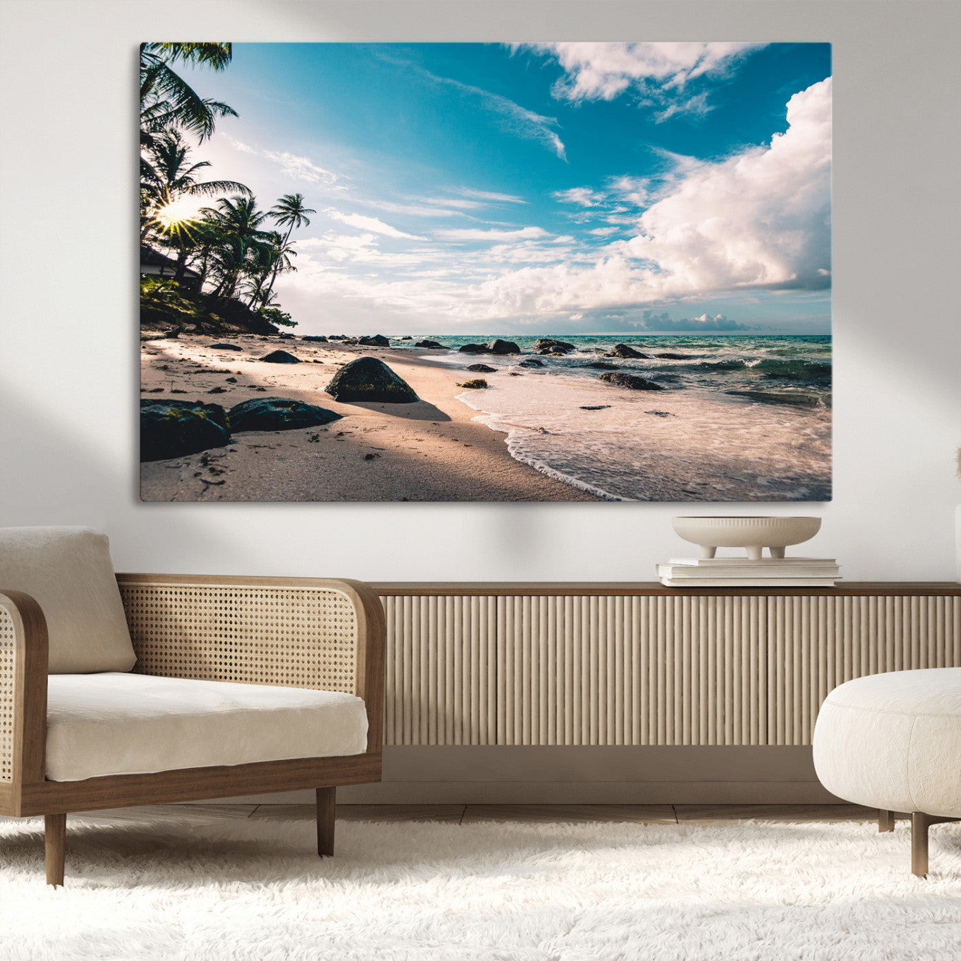 Scenic tropical beach with palm trees, ocean waves, and rocky shoreline under a bright blue sky, creating a serene coastal vibe.