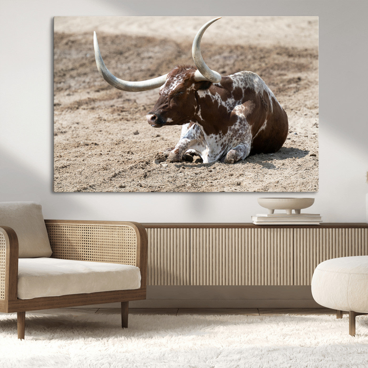 Texas Longhorn resting on sandy ground with large curved horns, capturing a rustic Western aesthetic perfect for farmhouse-style wall art.