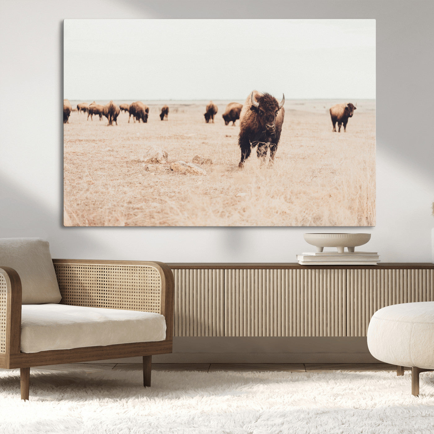 Herd of bison roaming a vast prairie with golden grass under a soft sky, creating a rustic and Western landscape, ideal for wall art.
