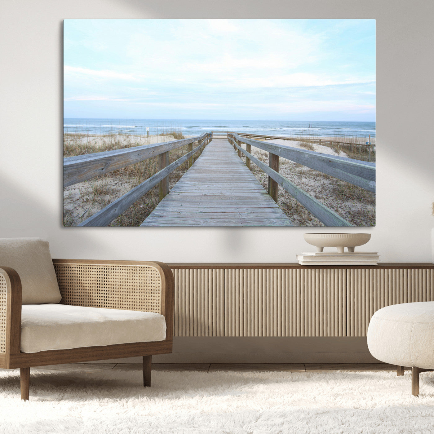Wooden boardwalk leading to a peaceful beach with gentle ocean waves under a soft pastel sky, perfect for coastal and nautical home decor.