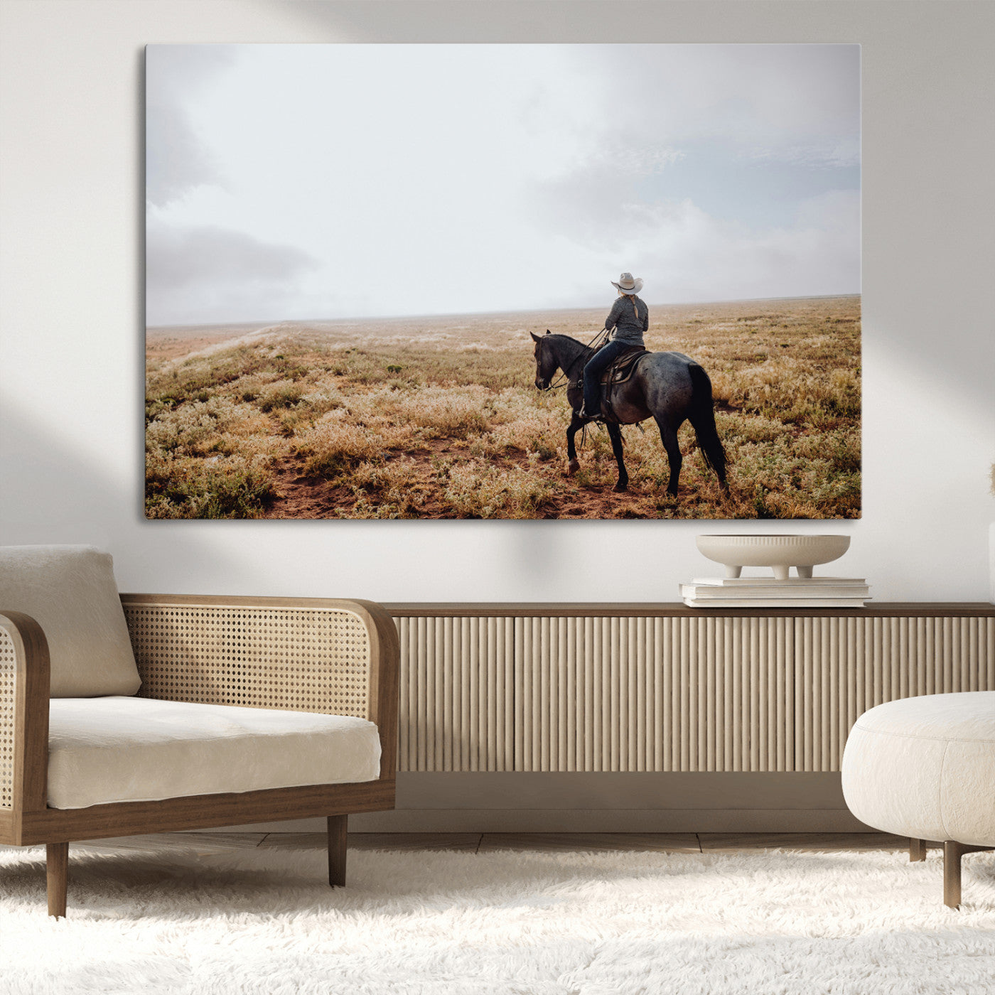 A lone cowboy riding horseback across an open prairie under a vast sky, capturing the rugged and timeless spirit of the Western frontier.