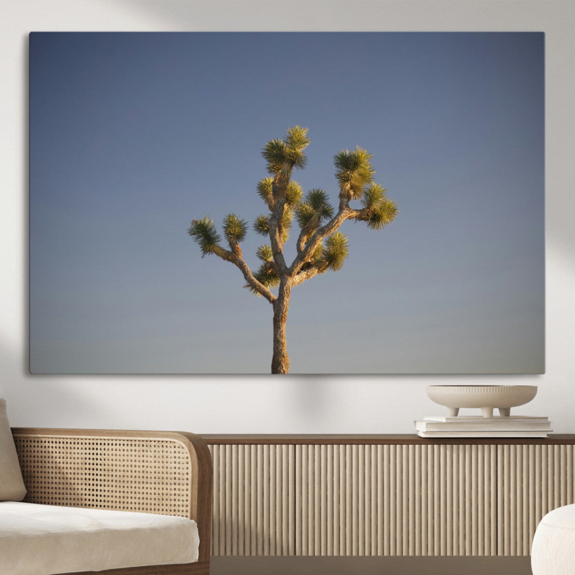 A lone Joshua Tree standing against a deep blue sky, capturing the serene and rugged beauty of the Southwestern desert landscape.
