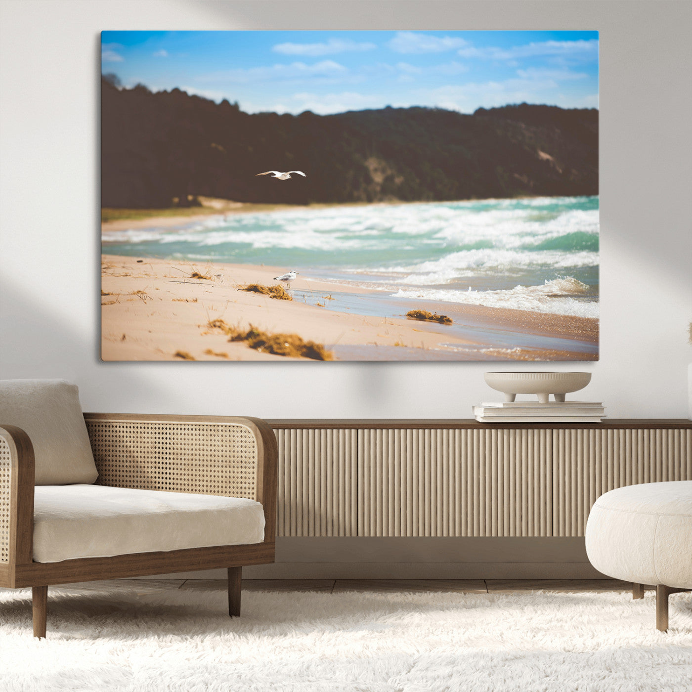 Serene beach scene with gentle ocean waves, sandy shore, and a seagull flying under a blue sky, perfect for coastal and nature-inspired decor.
