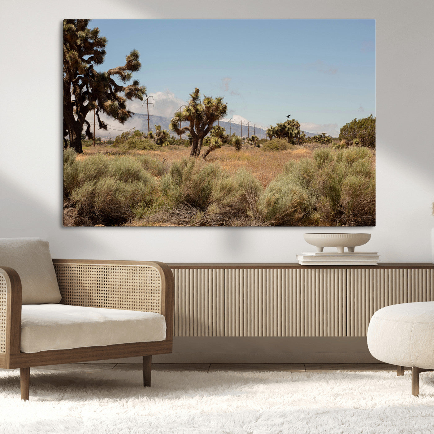 Scenic desert landscape with Joshua trees, dry grass, and distant mountains under a clear blue sky, perfect for southwestern and rustic decor.