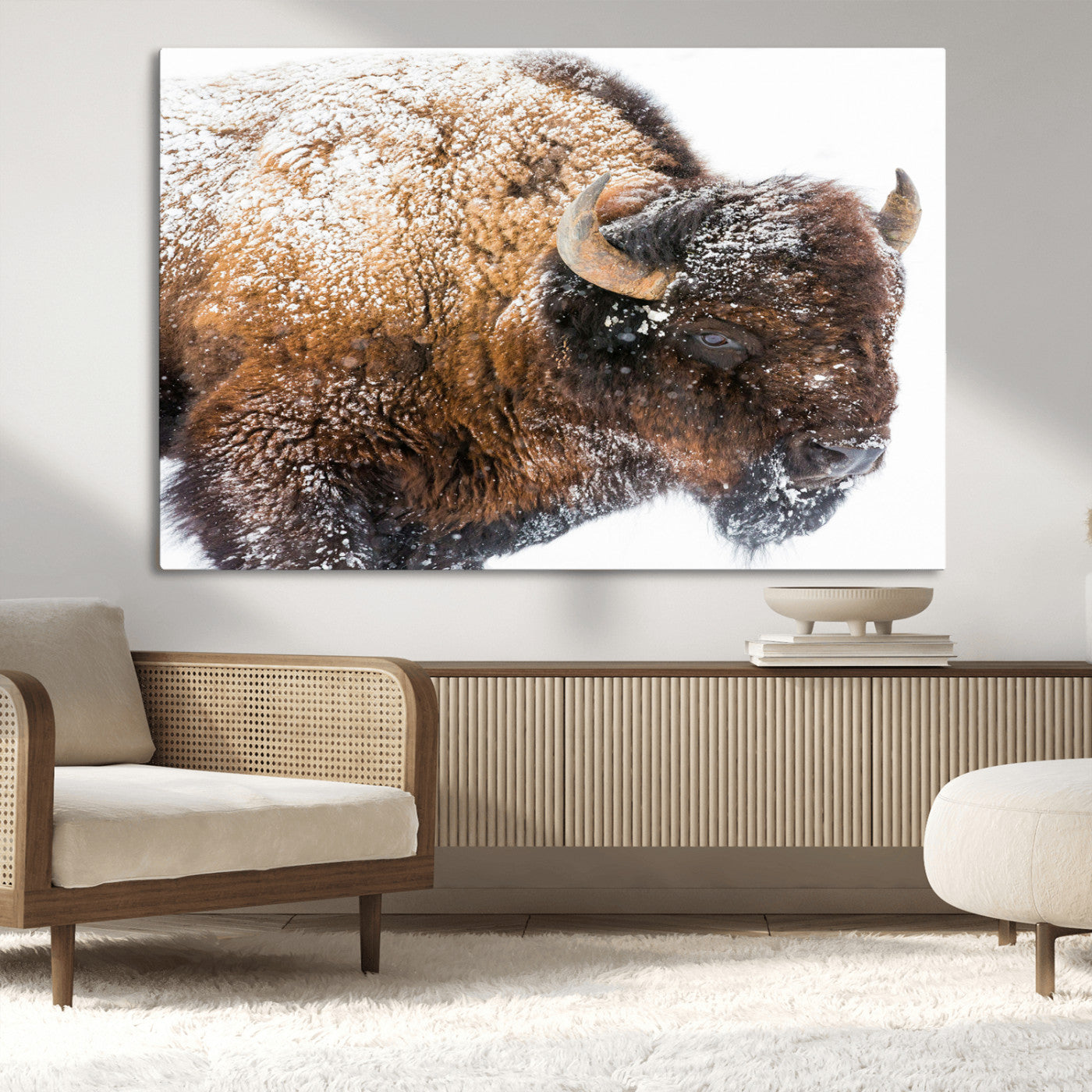 Close-up photograph of a bison covered in snow, highlighting its thick fur and powerful presence, set against a white winter backdrop, ideal for rustic decor.