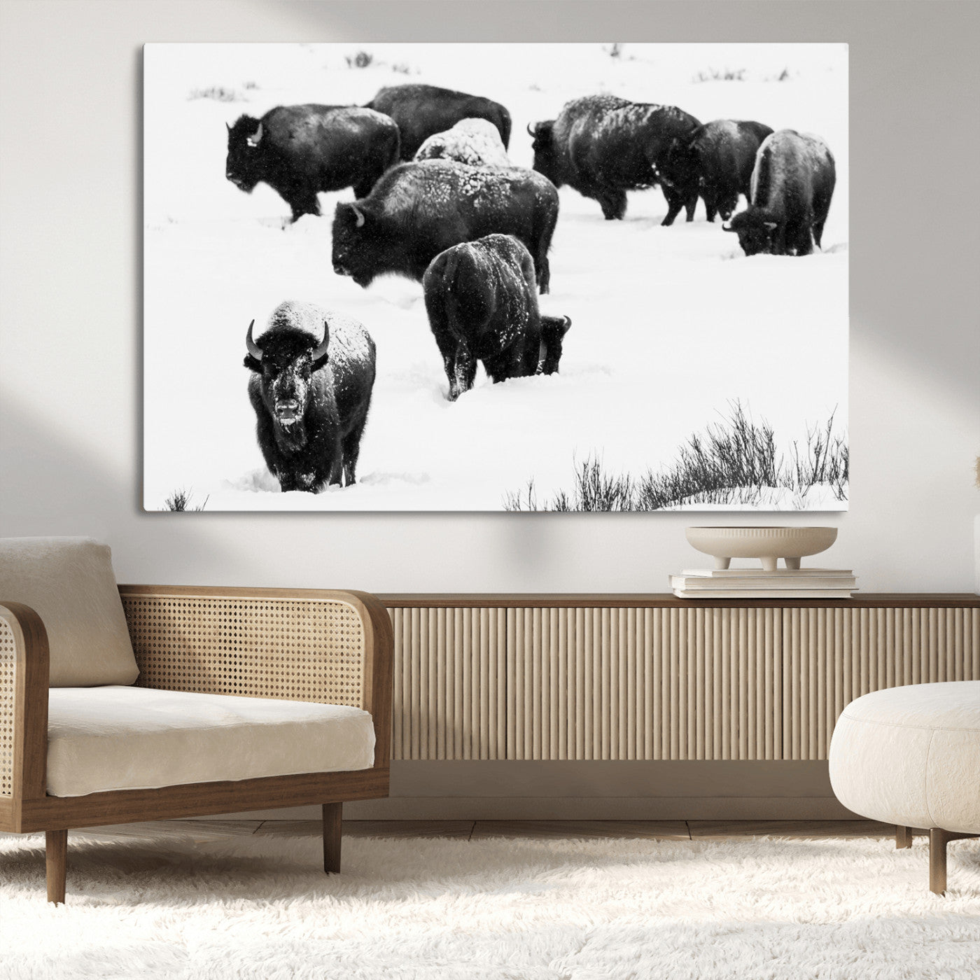 Black and white photograph of a bison herd in a snowy landscape, with snow-covered fur and a rugged wilderness setting, perfect for rustic lodge decor.