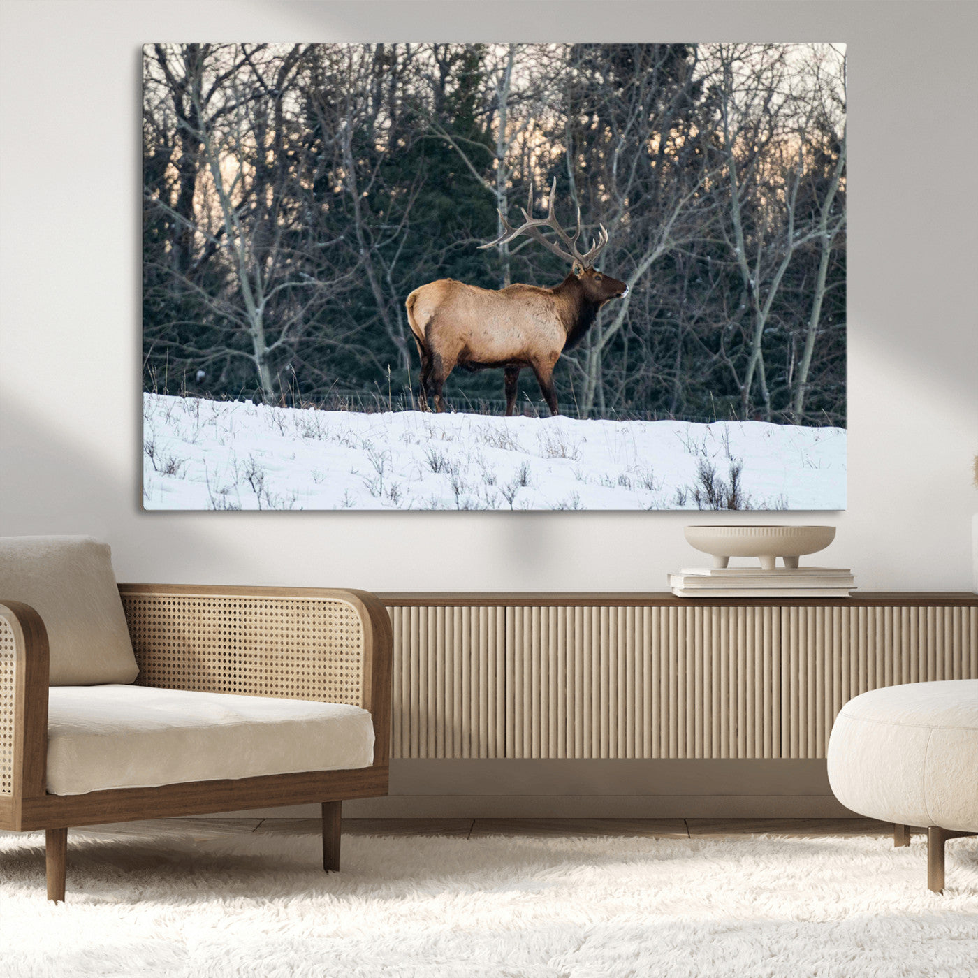 A majestic elk with large antlers standing in a snowy field against a winter forest backdrop, perfect for rustic and wildlife-themed home decor.