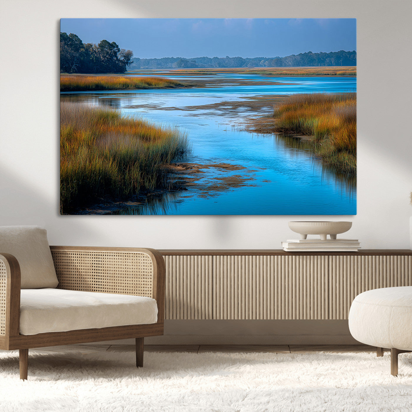 A peaceful marshland scene with calm blue water reflecting the surrounding grasses and trees, capturing the beauty of nature in a serene landscape.