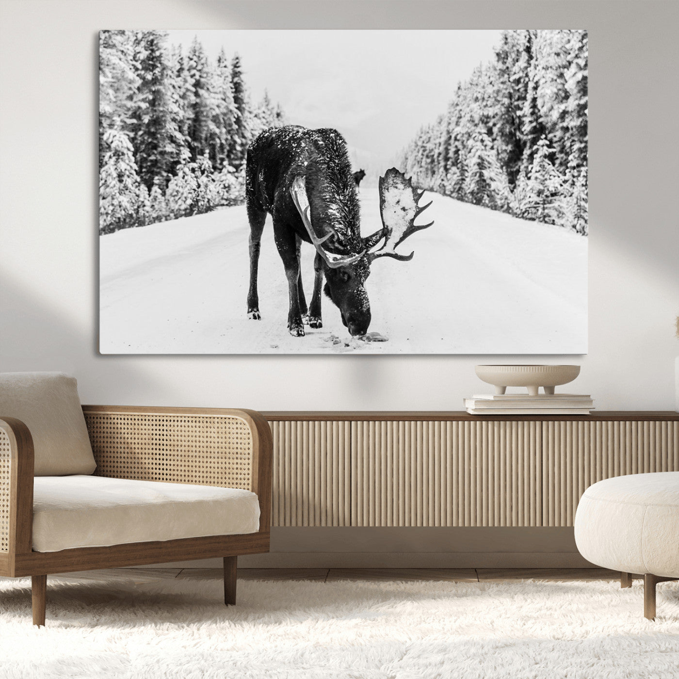 A majestic moose grazing in the snow-covered wilderness, surrounded by snow-covered trees, creating a peaceful winter scene.