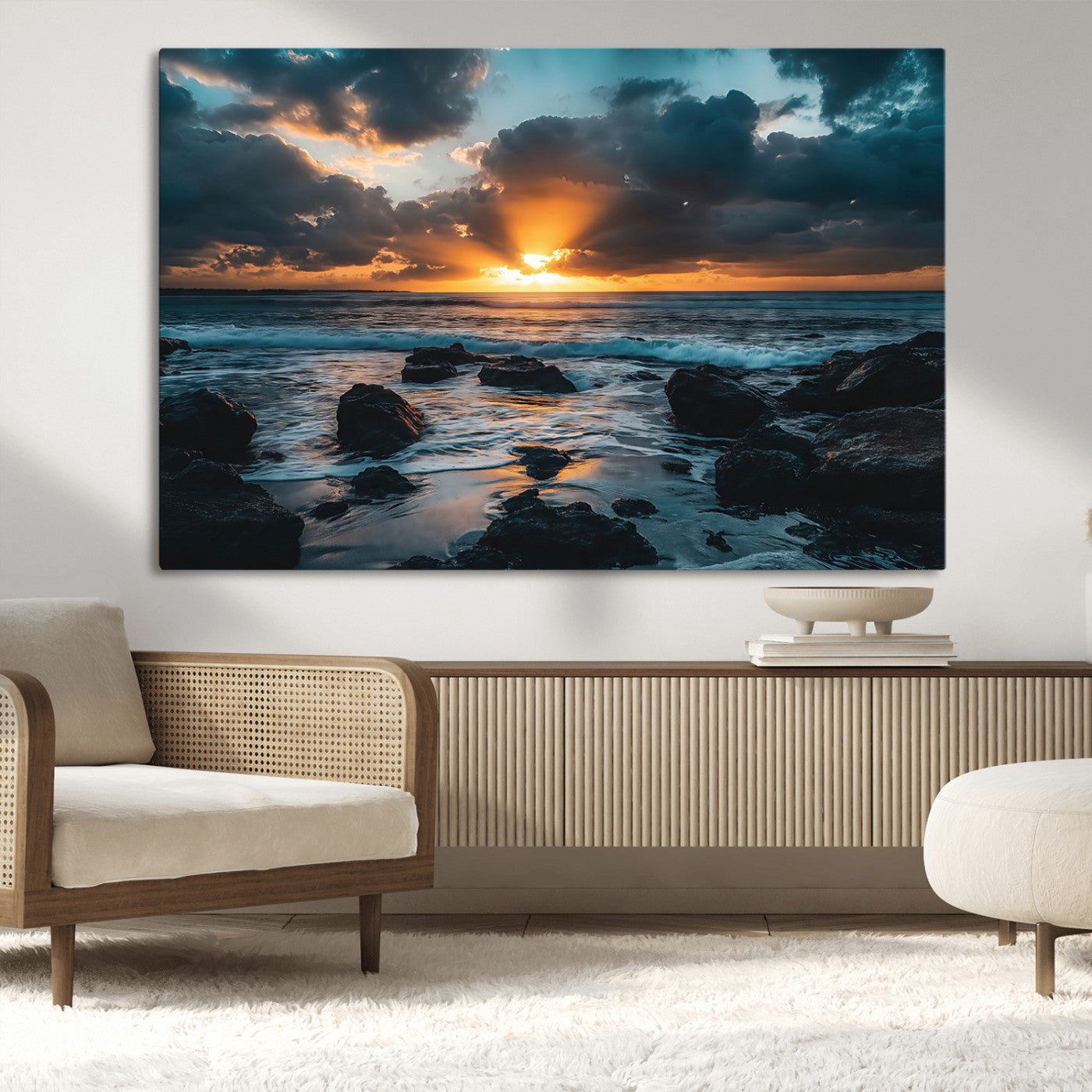 An awe-inspiring sunset over the ocean with rays of light piercing through dramatic clouds, creating a beautiful seascape with rocks in the foreground.