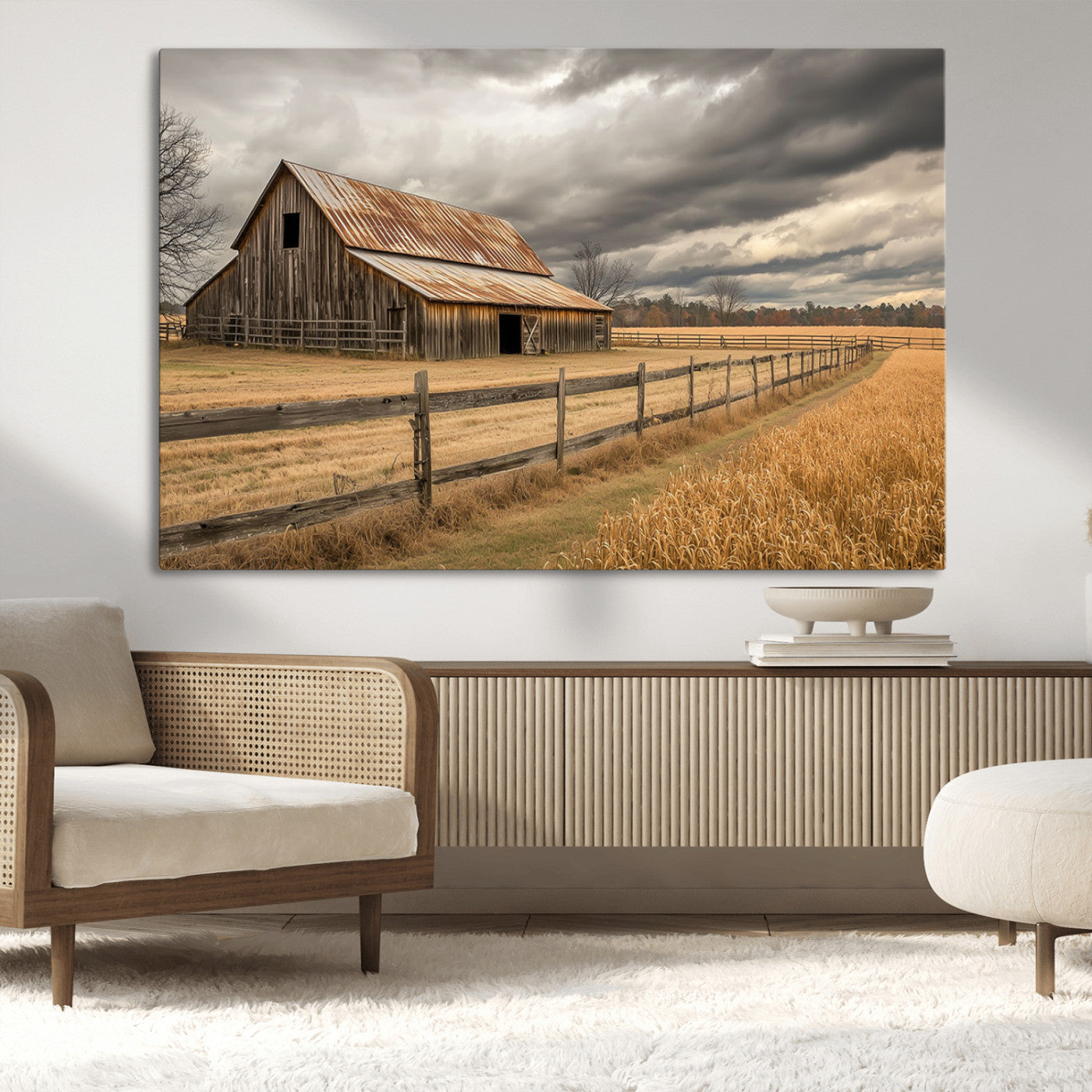 "Rustic barn with a weathered metal roof, surrounded by a wooden fence and golden fields under an overcast sky with dramatic clouds."