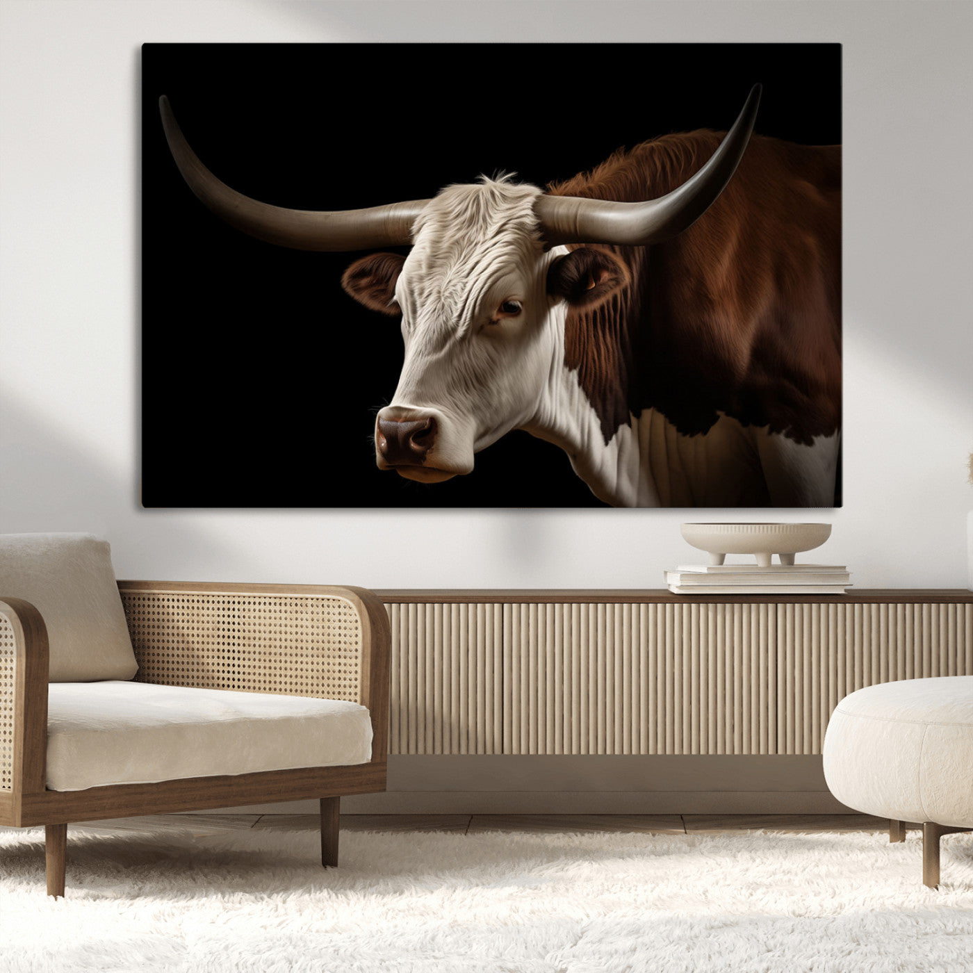 "Close-up of a brown and white longhorn cow with prominent curved horns against a black background."