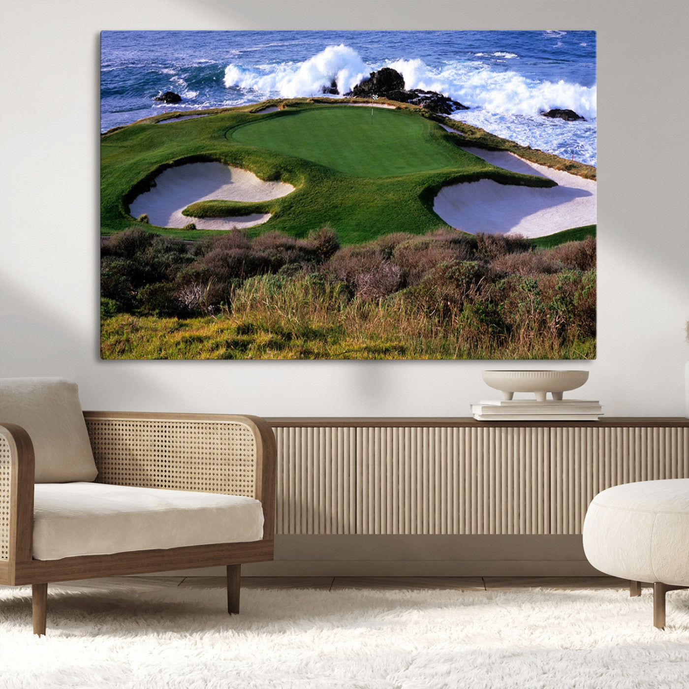 A scenic golf course located by the ocean, featuring a well-manicured green surrounded by sand traps and powerful ocean waves crashing on the shore.