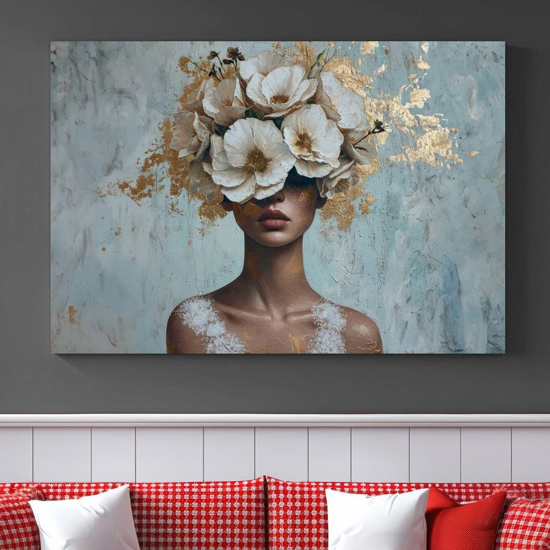 The Golden Petal Silhouette Woman Wall Art Canvas Print, a large 3-panel canvas with a textured gold floral design, serves as a luxurious centerpiece in modern glam settings. The artwork depicts a woman with flowers over her eyes against a textured background and hangs elegantly.