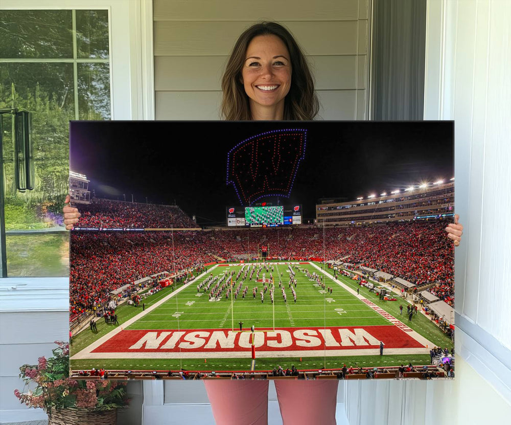 A premium canvas print captures a vibrant scene of Camp Randall Stadium featuring a lively football game with cheering fans and the energetic movements of the band.