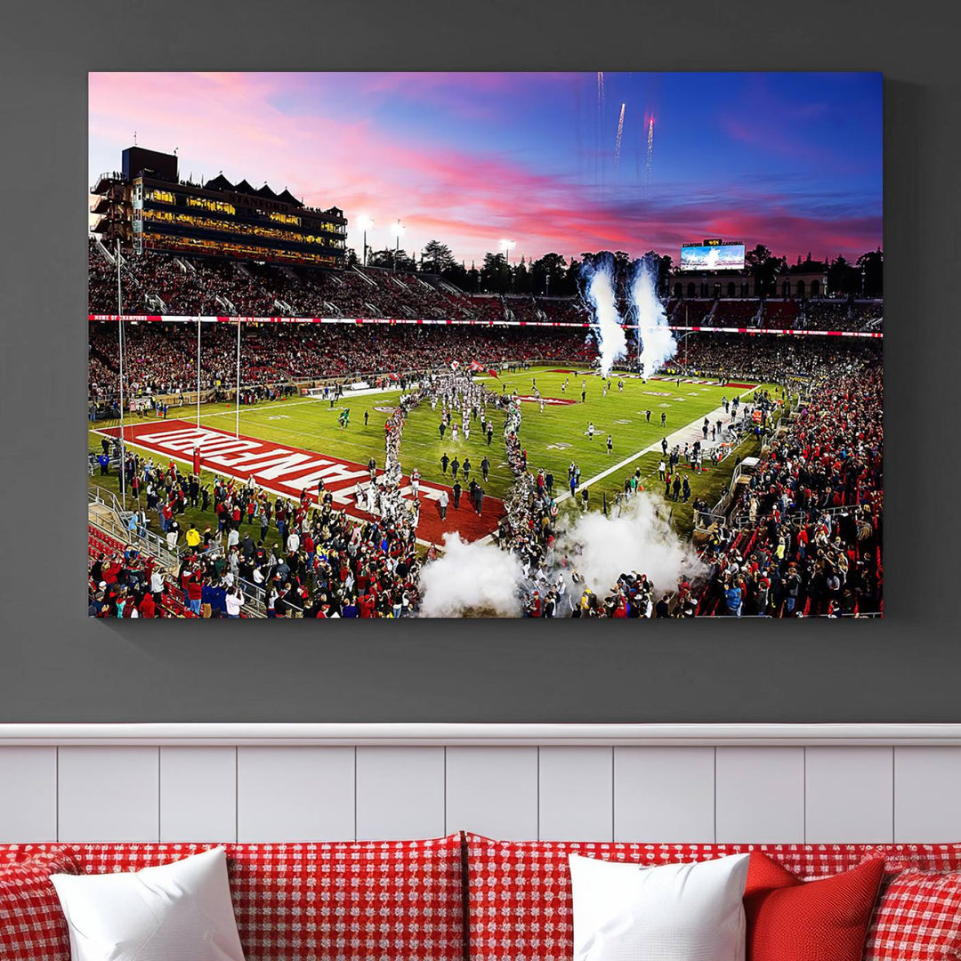 The wall art features a canvas print of the Stanford Cardinal football team, capturing players, fireworks, and smoke against the backdrop of a sunset at Stanford Stadium.