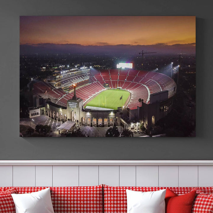 The USC Trojans Stadium canvas captures Memorial Coliseum at twilight, showcasing red seats and a green field beneath an orange sky.