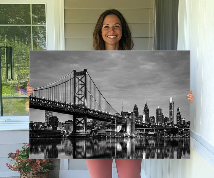 The "Large Wall Art Philadelphia Canvas Print" showcases a black-and-white depiction of the Ben Franklin Bridge with a water reflection.