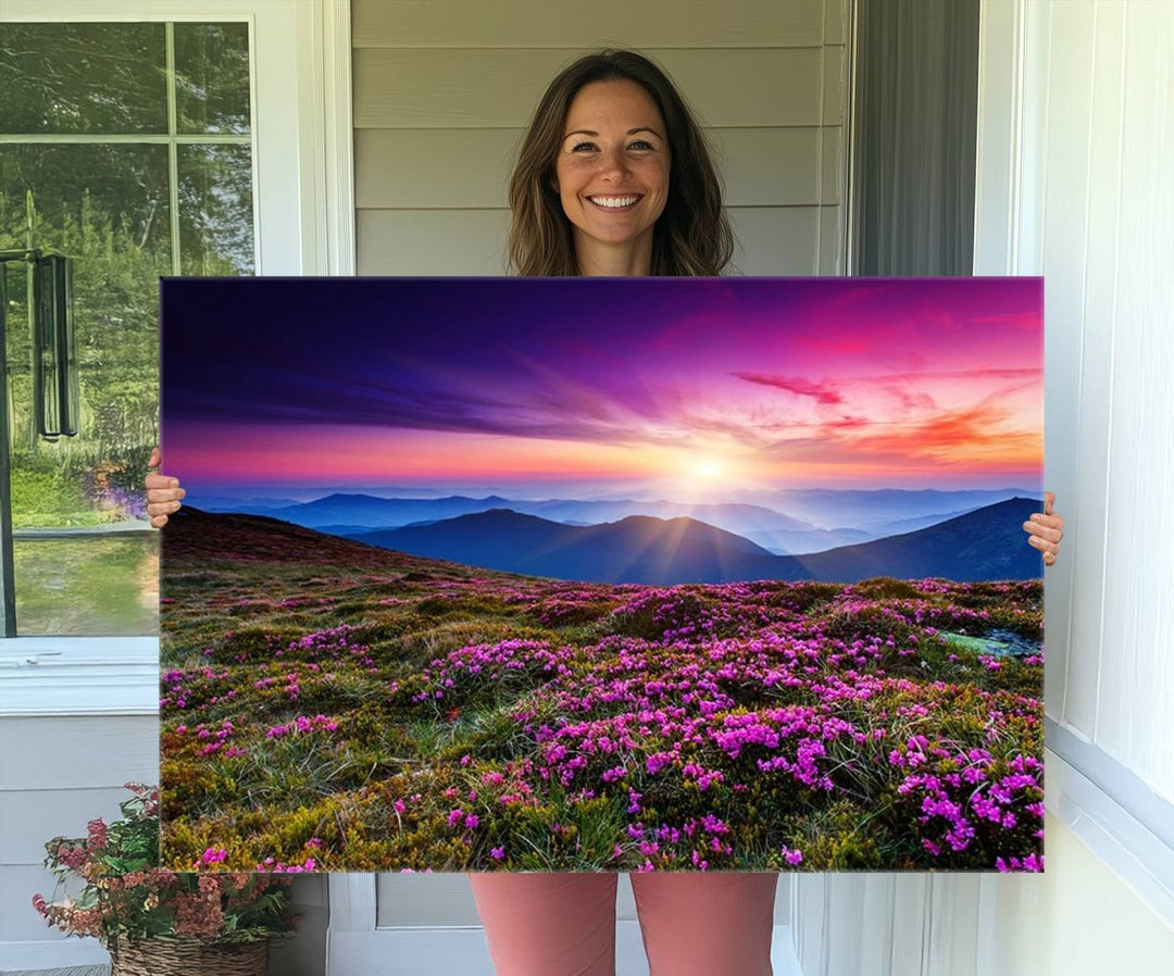 A 3-panel landscape photography canvas of a sunset over mountain meadows with purple wildflowers decorates the wall.