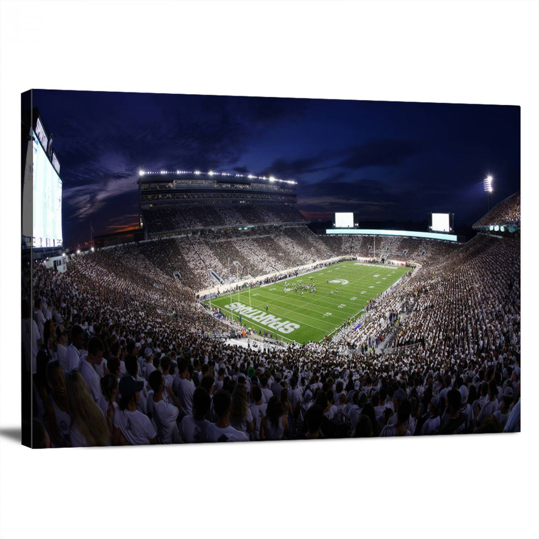 A packed football stadium at night, with bright lights and fans in white, depicted in a Michigan State Spartans Stadium wall art.